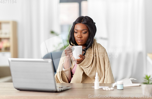 Image of sick woman with tea having video call on laptop