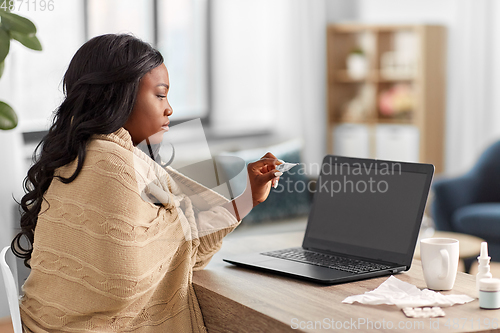 Image of sick woman having video call on laptop at home