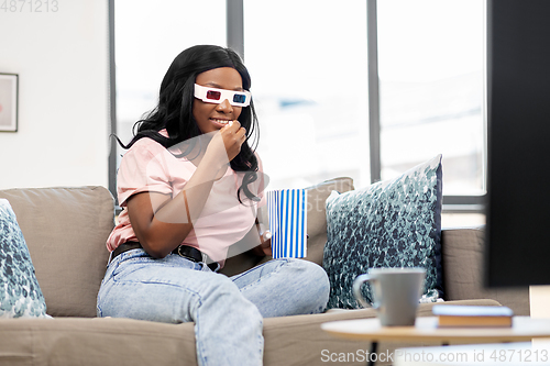 Image of happy african american woman watching tv at home