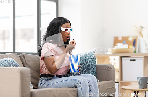 Image of african american woman watching tv at home