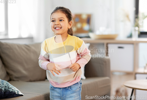 Image of happy smiling little girl at home