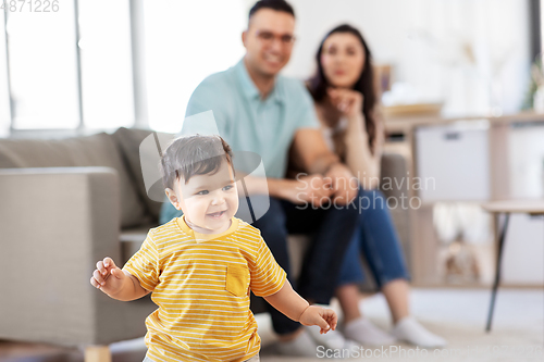 Image of happy baby boy and parents at home