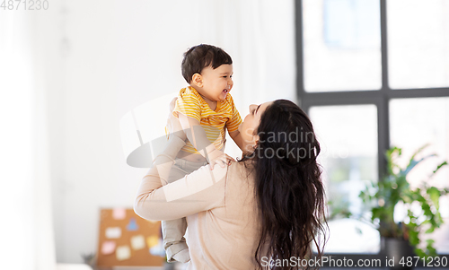 Image of happy mother with little baby son at home