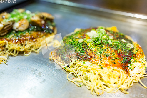 Image of Japanese savoury pancake containing a variety ingredients