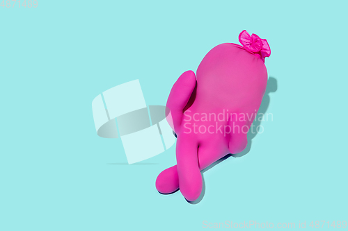Image of Life of rubber glove like a person - protective wear isolated on blue studio background