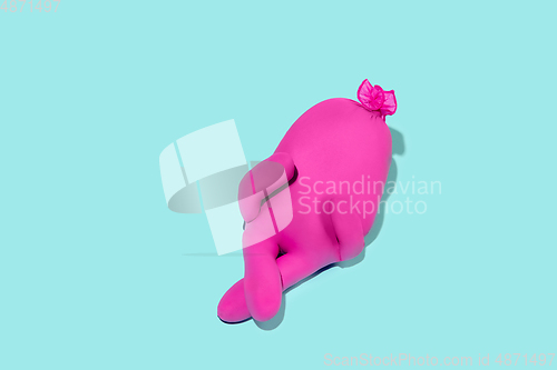 Image of Life of rubber glove like a person - protective wear isolated on blue studio background