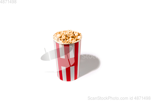 Image of Striped white red bucket full of popcorn isolated on white studio background with copyspace