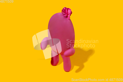 Image of Life of rubber glove like a person - protective wear isolated on yellow studio background