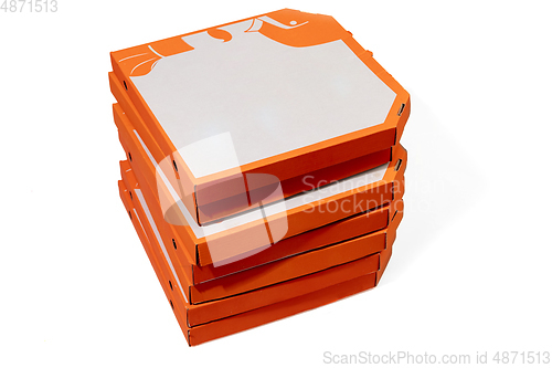 Image of Close up of carton orange boxes for pizza isolated on white studio background with copyspace