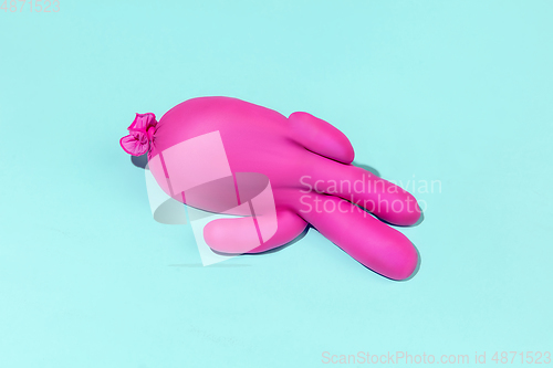 Image of Life of rubber glove like a person - protective wear isolated on blue studio background