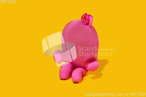 Image of Life of rubber glove like a person - protective wear isolated on yellow studio background