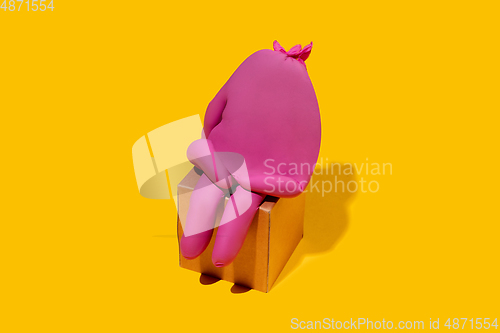 Image of Life of rubber glove like a person - protective wear isolated on yellow studio background