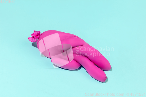 Image of Life of rubber glove like a person - protective wear isolated on blue studio background