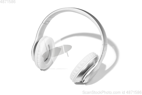 Image of Wireless white headphones isolated on a white studio background with copyspace. Modern bluetooth technologies