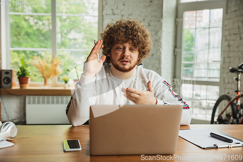 Image of Manager or student working from home while being insulated or keep quarantine \'cause of coronavirus COVID-19. Online meeting.