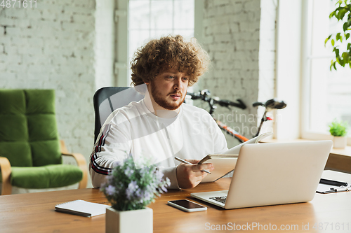 Image of Manager or student working from home while being insulated or keep quarantine \'cause of coronavirus COVID-19. Making notes.