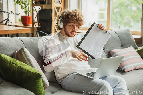 Image of Manager or student working from home while being insulated or keep quarantine \'cause of coronavirus COVID-19. Conference online with colleague.