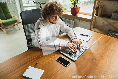 Image of Manager or student working from home while being insulated or keep quarantine \'cause of coronavirus COVID-19. Typing text, report.