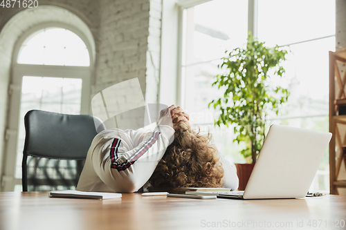 Image of Manager or student working from home while being insulated or keep quarantine \'cause of coronavirus COVID-19. Tired, scared.