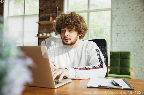 Image of Manager or student working from home while being insulated or keep quarantine \'cause of coronavirus COVID-19. Typing text, report.