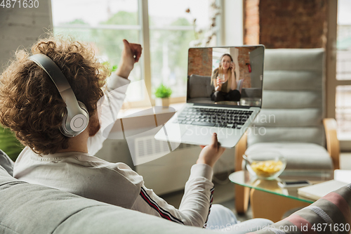 Image of Manager or student working from home while being insulated or keep quarantine \'cause of coronavirus COVID-19. Conference online with colleague.