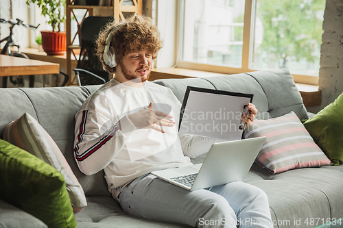 Image of Manager or student working from home while being insulated or keep quarantine \'cause of coronavirus COVID-19. Conference online with colleague.