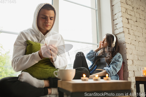 Image of Quarantine lockdown, stay home concept - young beautiful caucasian couple enjoying new lifestyle during coronavirus worldwide health emergency