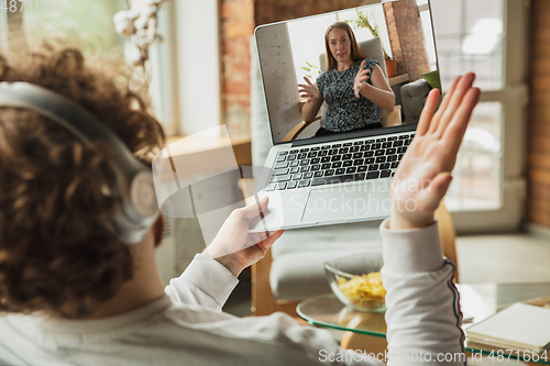 Image of Manager or student working from home while being insulated or keep quarantine \'cause of coronavirus COVID-19. Conference online with colleague.