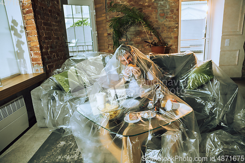 Image of Senior man covered with plastic, eating fast food and drinking beer - environmental pollution by people concept