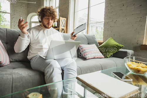 Image of Manager or student working from home while being insulated or keep quarantine \'cause of coronavirus COVID-19. Conference online with colleague.