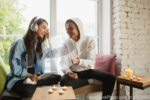 Image of Quarantine lockdown, stay home concept - young beautiful caucasian couple enjoying new lifestyle during coronavirus worldwide health emergency