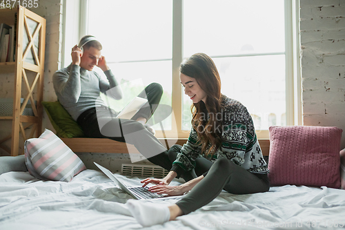 Image of Quarantine lockdown, stay home concept - young beautiful caucasian couple enjoying new lifestyle during coronavirus worldwide health emergency