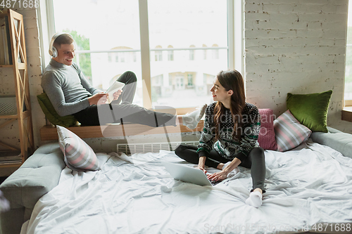 Image of Quarantine lockdown, stay home concept - young beautiful caucasian couple enjoying new lifestyle during coronavirus worldwide health emergency