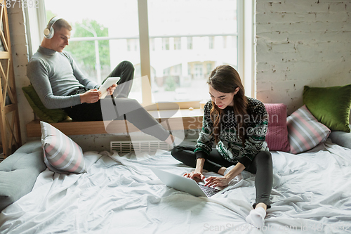 Image of Quarantine lockdown, stay home concept - young beautiful caucasian couple enjoying new lifestyle during coronavirus worldwide health emergency