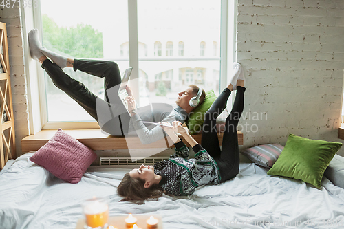 Image of Quarantine lockdown, stay home concept - young beautiful caucasian couple enjoying new lifestyle during coronavirus worldwide health emergency