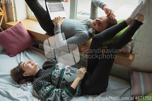 Image of Quarantine lockdown, stay home concept - young beautiful caucasian couple enjoying new lifestyle during coronavirus worldwide health emergency