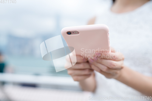 Image of Woman using mobile phone online