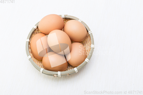 Image of Egg in basket isolated on white