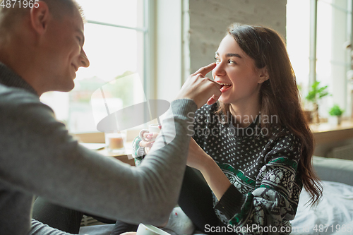 Image of Quarantine lockdown, stay home concept - young beautiful caucasian couple enjoying new lifestyle during coronavirus worldwide health emergency