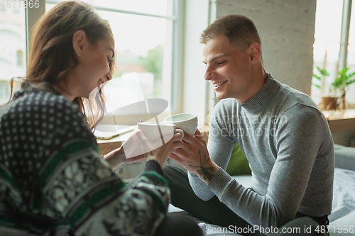 Image of Quarantine lockdown, stay home concept - young beautiful caucasian couple enjoying new lifestyle during coronavirus worldwide health emergency