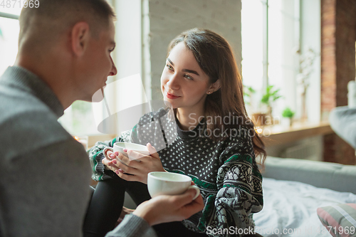 Image of Quarantine lockdown, stay home concept - young beautiful caucasian couple enjoying new lifestyle during coronavirus worldwide health emergency