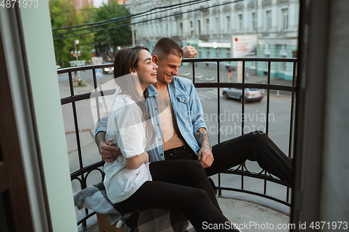 Image of Quarantine lockdown, stay home concept - young beautiful caucasian couple enjoying new lifestyle during coronavirus worldwide health emergency