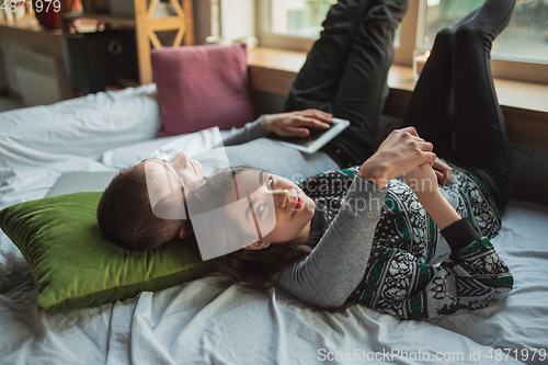 Image of Quarantine lockdown, stay home concept - young beautiful caucasian couple enjoying new lifestyle during coronavirus worldwide health emergency