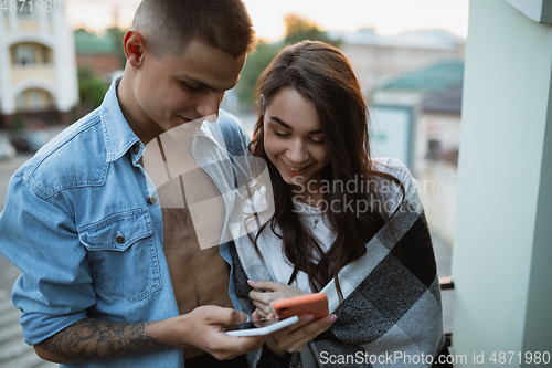 Image of Quarantine lockdown, stay home concept - young beautiful caucasian couple enjoying new lifestyle during coronavirus worldwide health emergency