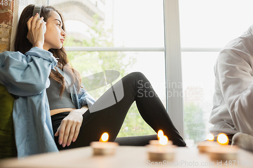 Image of Quarantine lockdown, stay home concept - young caucasian woman enjoying new lifestyle during coronavirus worldwide health emergency