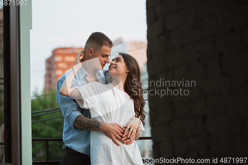 Image of Quarantine lockdown, stay home concept - young beautiful caucasian couple enjoying new lifestyle during coronavirus worldwide health emergency