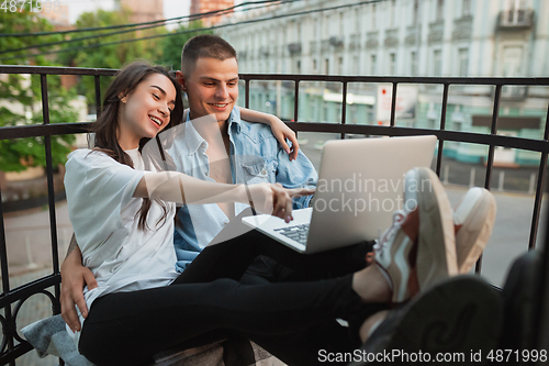 Image of Quarantine lockdown, stay home concept - young beautiful caucasian couple enjoying new lifestyle during coronavirus worldwide health emergency