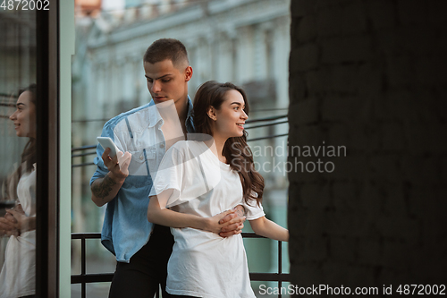 Image of Quarantine lockdown, stay home concept - young beautiful caucasian couple enjoying new lifestyle during coronavirus worldwide health emergency