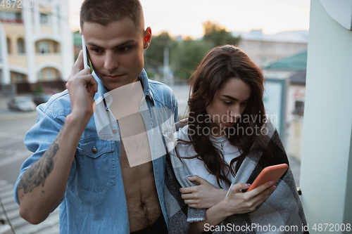 Image of Quarantine lockdown, stay home concept - young beautiful caucasian couple enjoying new lifestyle during coronavirus worldwide health emergency