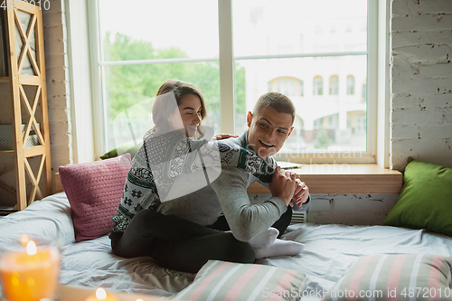 Image of Quarantine lockdown, stay home concept - young beautiful caucasian couple enjoying new lifestyle during coronavirus worldwide health emergency